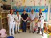 Professionals del servei de Pediatria del Trueta amb una representació de la  junta de govern del Col·legi d'Aparelladors, Arquitectes tècnics i Enginyers de Girona